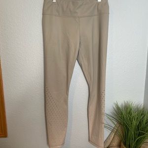 Athleta tannish colored 7/8 length leggings with laser cutouts on bottom